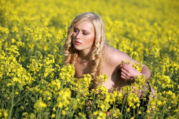 stock image Beautiful young blonde woman in a field of wildflowers.