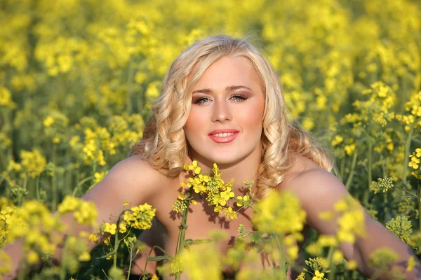 stock image Beautiful young blonde woman in a field of wildflowers.